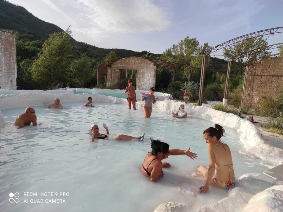 a group of people playing in a swimming pool at La Casetta in San Giovanni delle Contee