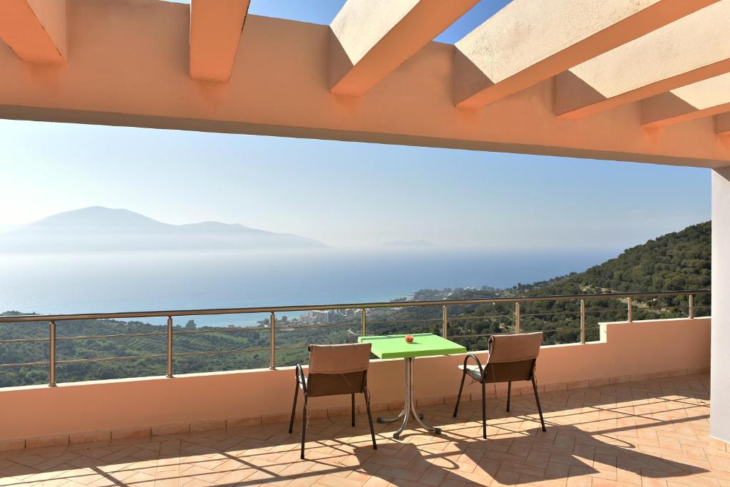 a balcony with a table and chairs and the ocean at Vila Merkuri - 3-Storey Villa with Sea View in Vlorë