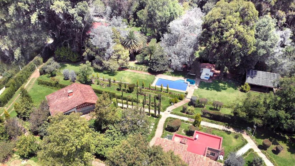 an aerial view of a house with a yard at Cabin Aguacate Natural Getaway Amazing Amenities in Zitácuaro