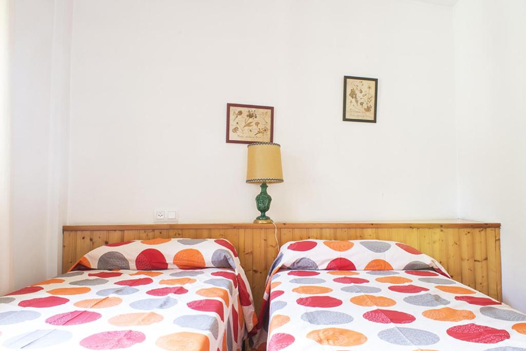 A bed or beds in a room at Apartamentos Grist