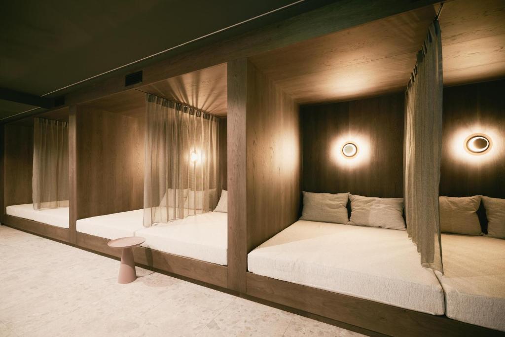 Postel nebo postele na pokoji v ubytování TRIFORÊT alpin resort