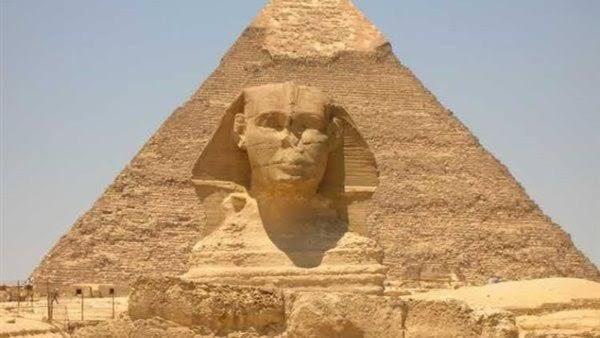 a statue of aaraoh in front of a pyramid at Tapiri pyramids inn in Cairo