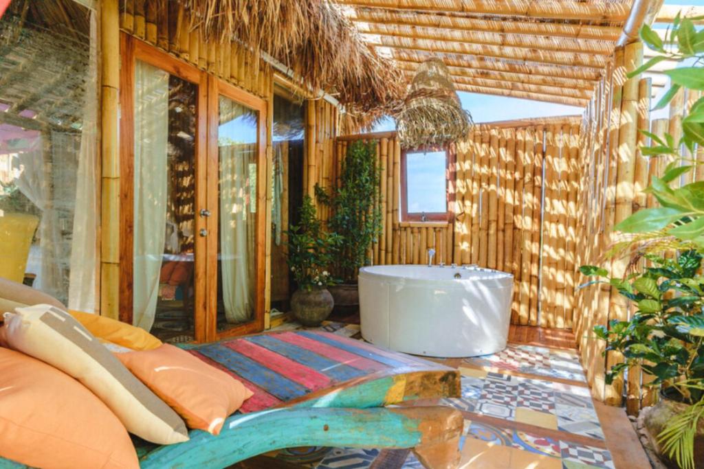a bathroom with a tub and a table with pillows at Beach bungalow Aruba in Savaneta
