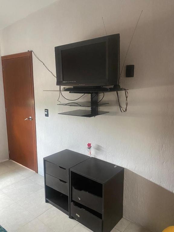 a flat screen tv sitting on a wall at Casa Muñoz in San Agustín