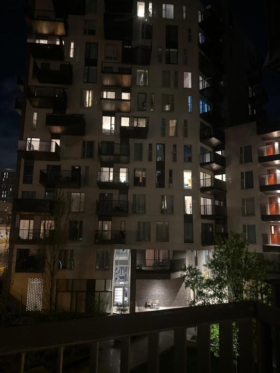 a tall apartment building at night at Simply lux apartment in London