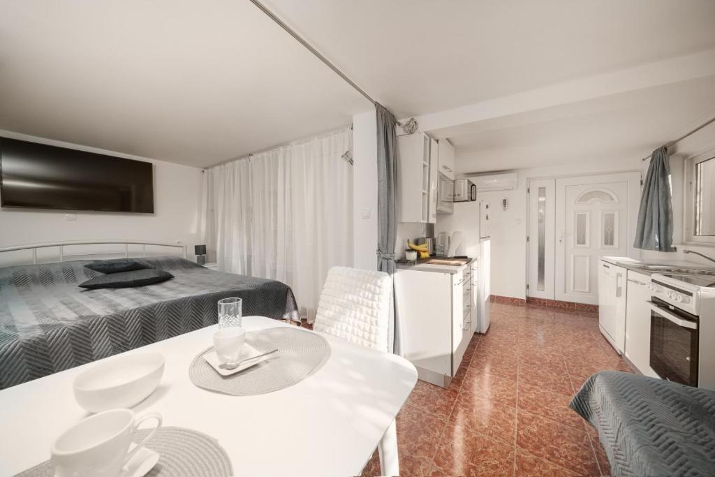 una camera con letto e tavolo e una cucina di Studio Apartman Vodice a Vodice