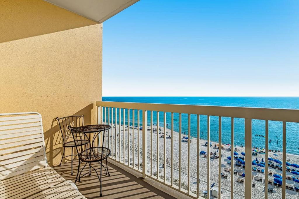 a balcony with chairs and tables and the ocean at Calypso Resort & Towers in Panama City Beach