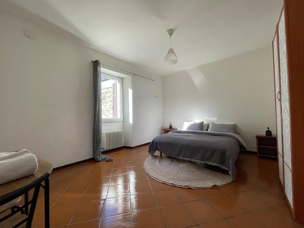 a bedroom with a bed and a large window at A D R Holiday Home in Casale Corte Cerro