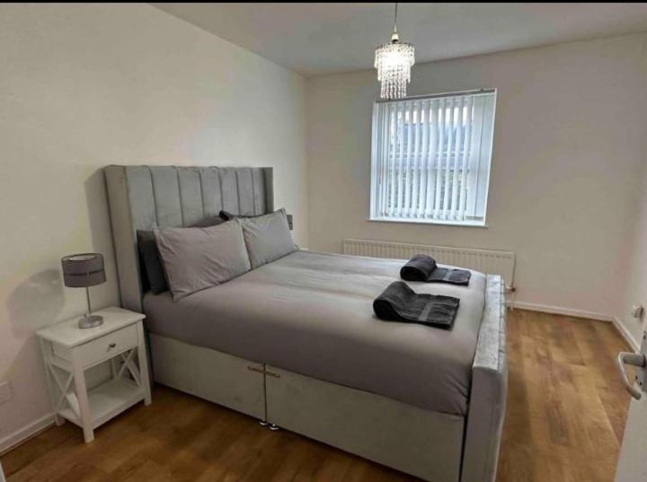 a bedroom with a large bed and a window at The NEW! 2 Bedroom London House with Garden and Lawn in London