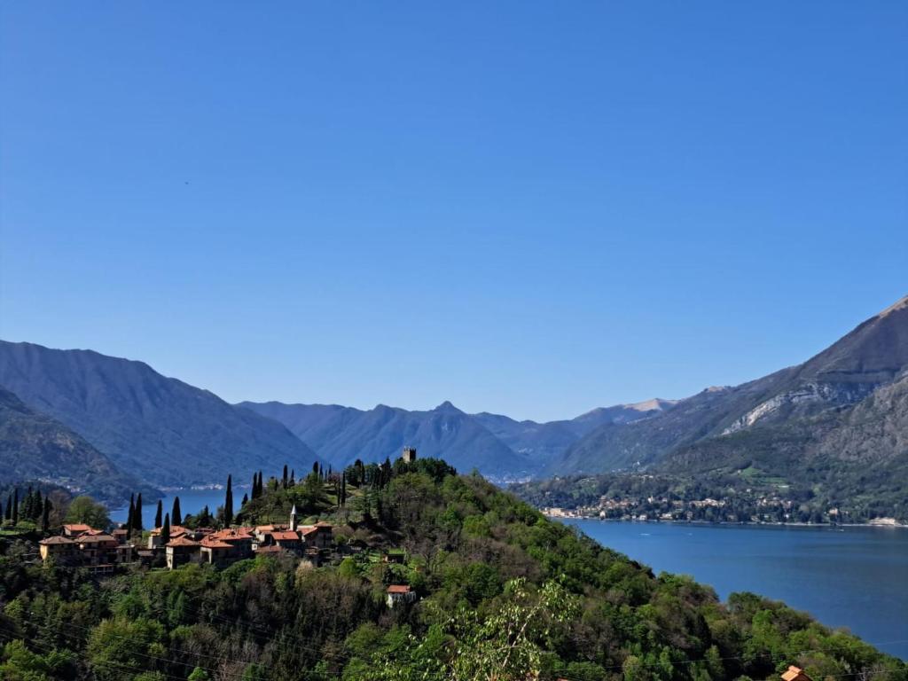 a house on top of a hill next to a lake at La casa di Guia in Perledo