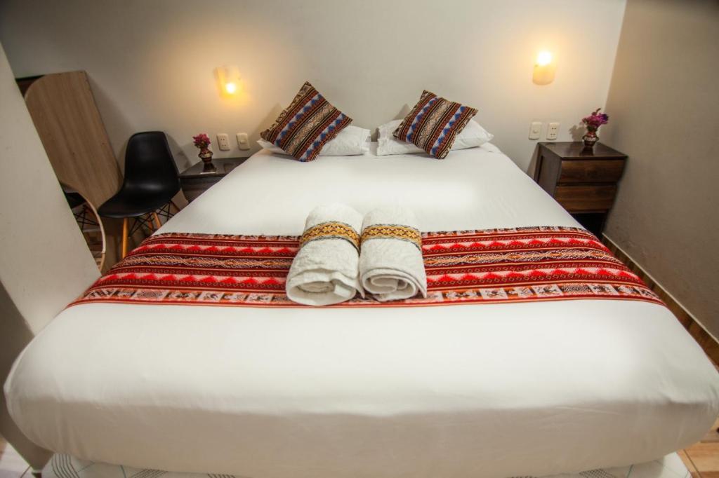 Postel nebo postele na pokoji v ubytování RUMIQOLQA Machupicchu Hotel