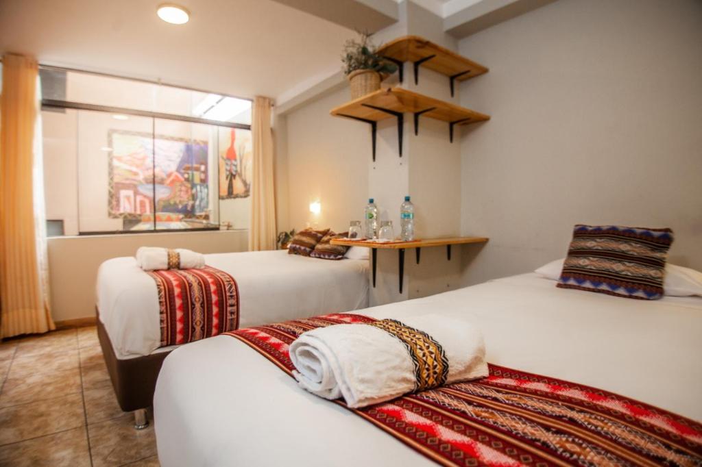 Postel nebo postele na pokoji v ubytování RUMIQOLQA Machupicchu Hotel