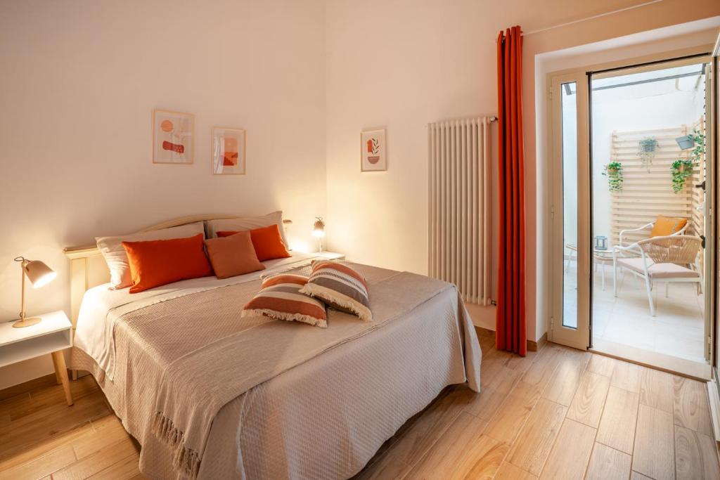 a bedroom with a bed with orange pillows on it at Dante95 in Polignano a Mare