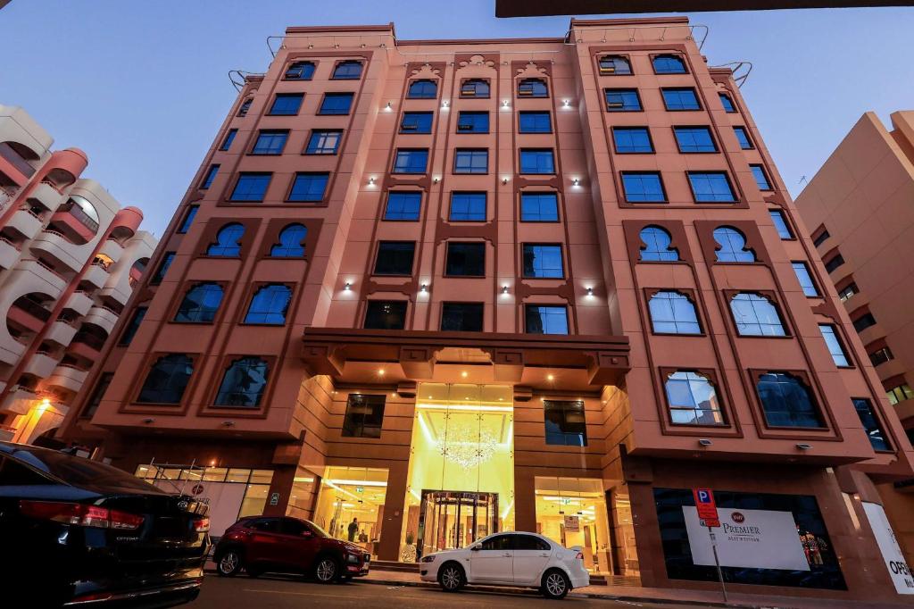 a tall building with cars parked in front of it at Best Western Premier M Four Hotel in Dubai