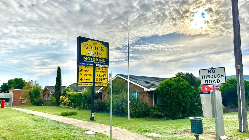 un paio di cartelli stradali davanti a una casa di Golden Grain Motor Inn a Tamworth