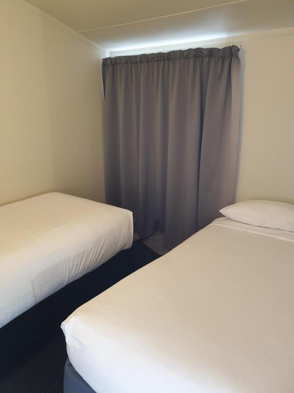 Postel nebo postele na pokoji v ubytování Northcote Motor Lodge