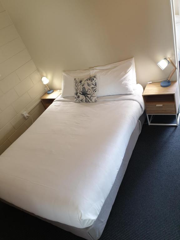 Postel nebo postele na pokoji v ubytování Northcote Motor Lodge