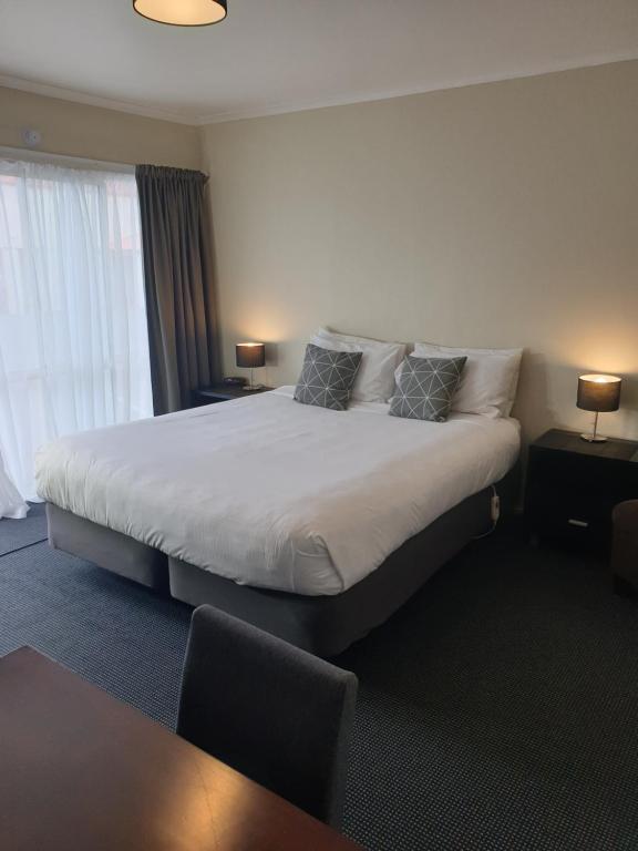 Postel nebo postele na pokoji v ubytování Northcote Motor Lodge