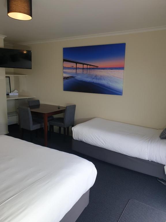 Postel nebo postele na pokoji v ubytování Northcote Motor Lodge