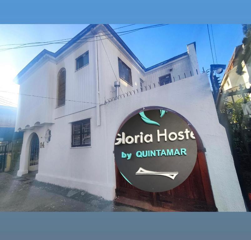 a white building with a sign in front of it at Hostal Gloria Viña in Viña del Mar