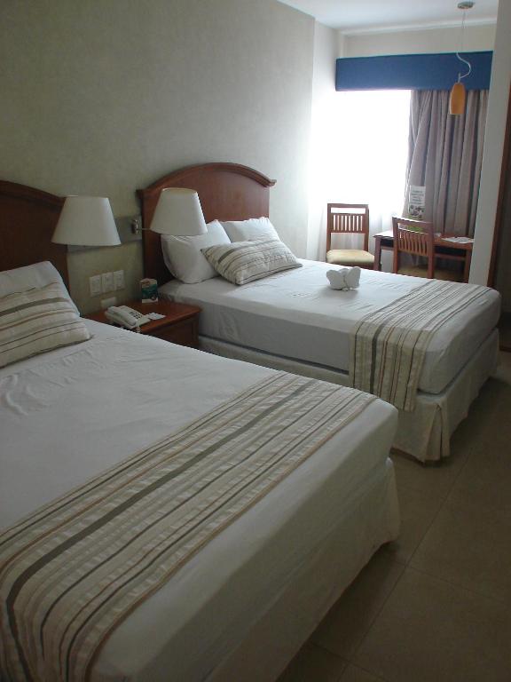Postel nebo postele na pokoji v ubytování Hotel Ruiz Milán