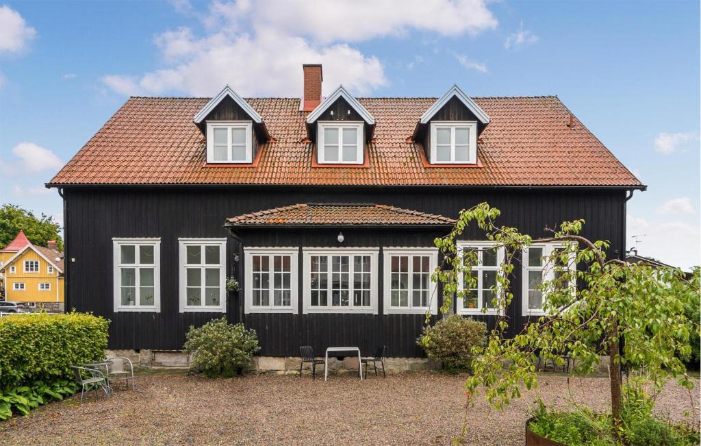 una casa negra con techo rojo en 1 Bedroom Awesome Apartment In Stenkullen, en Stenkullen