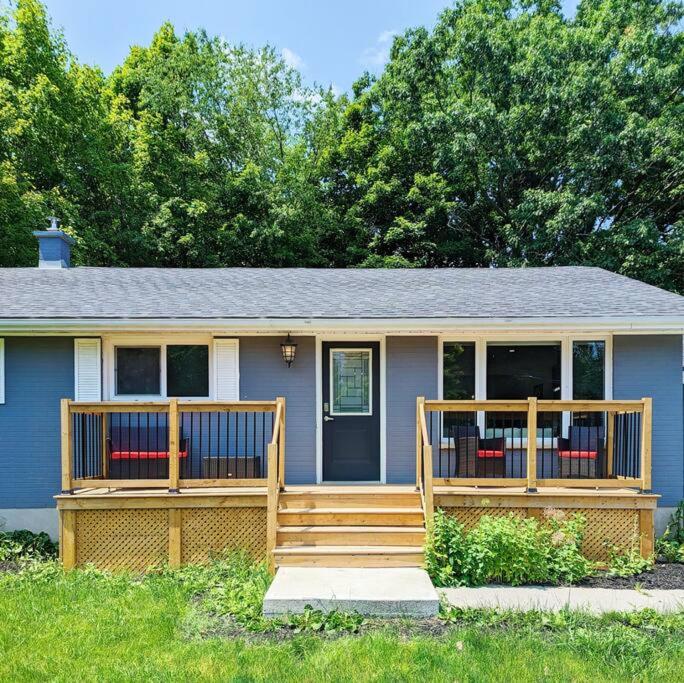 a small house with a porch and a deck at The Lilac Bungalow in Kingston