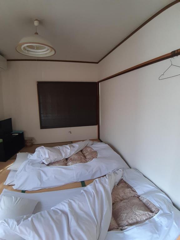 Postel nebo postele na pokoji v ubytování guest house komoriya