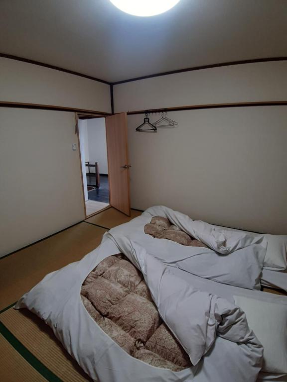 Postel nebo postele na pokoji v ubytování guest house komoriya