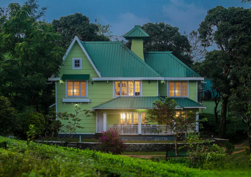 a green house with a green roof at Lavender Plantation Stay vagamon in Vagamon