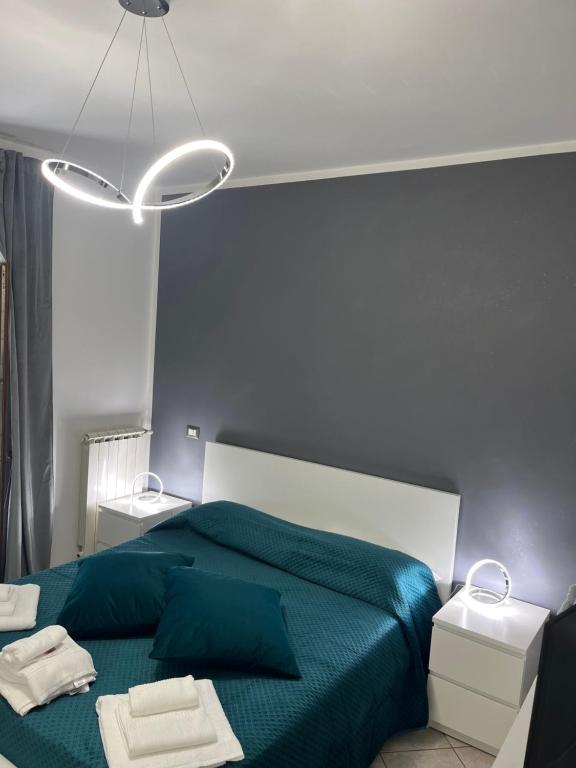 フィウミチーノにあるLa perla del mareのベッドルーム1室(緑のベッド1台、タオル2枚付)
