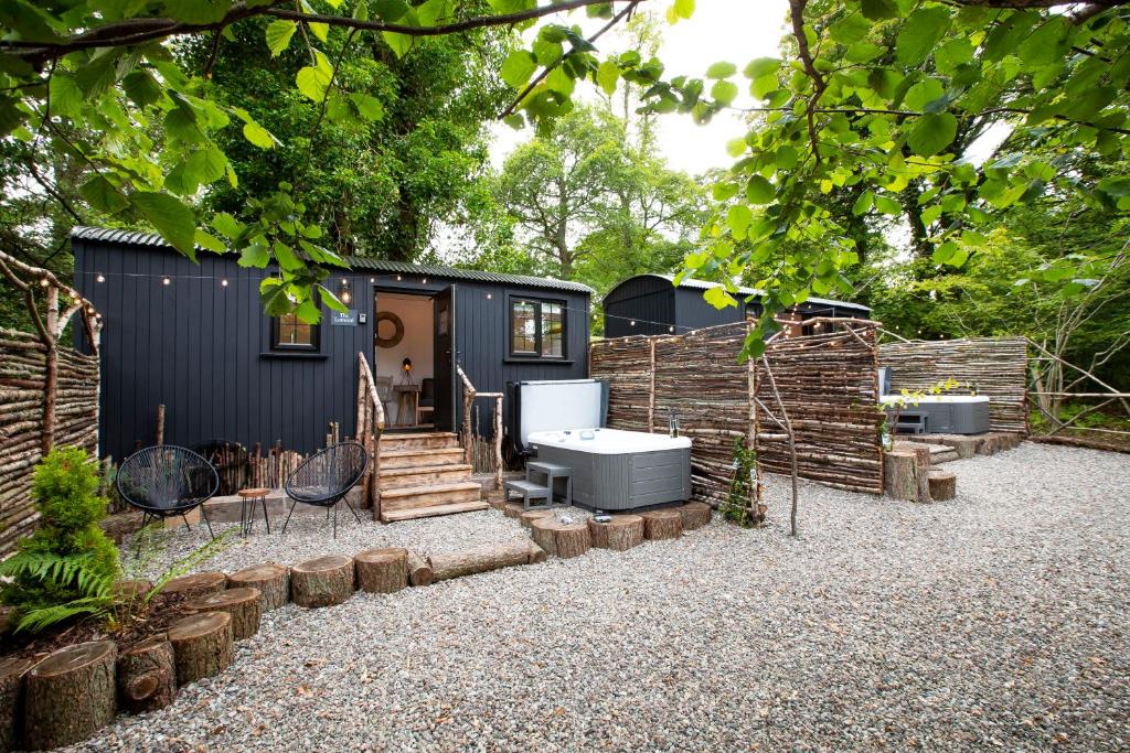 a tiny house with a bathroom and a fence at The Mar Huts - The Lomond Hut in Drymen