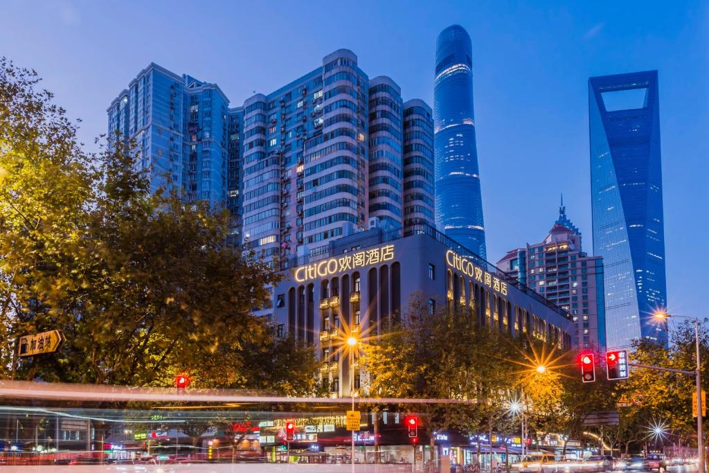 a city skyline with tall buildings at night at CitiGO Hotel Lujiazui Shanghai in Shanghai