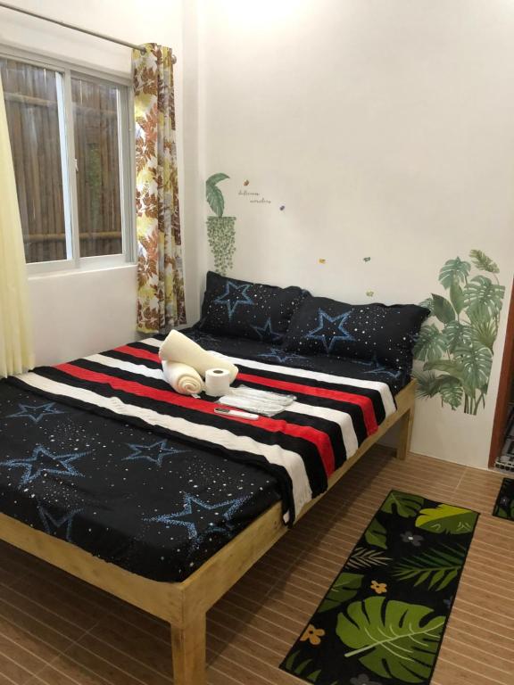 a bed sitting in a room with at Maligaya Maison in General Luna