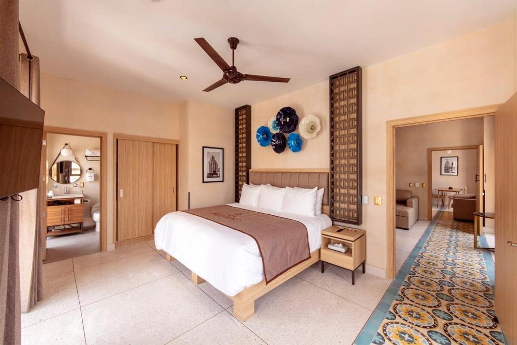 a bedroom with a large bed with a ceiling fan at Master suite steps from Bellas artes in Mexico City