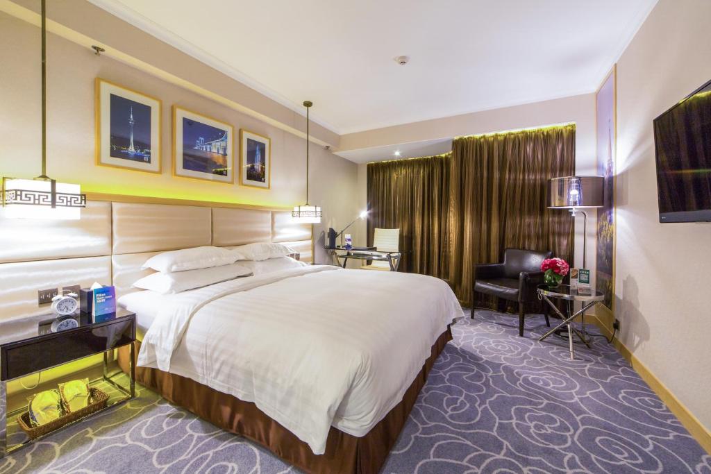 Postel nebo postele na pokoji v ubytování Metropark Hotel Macau