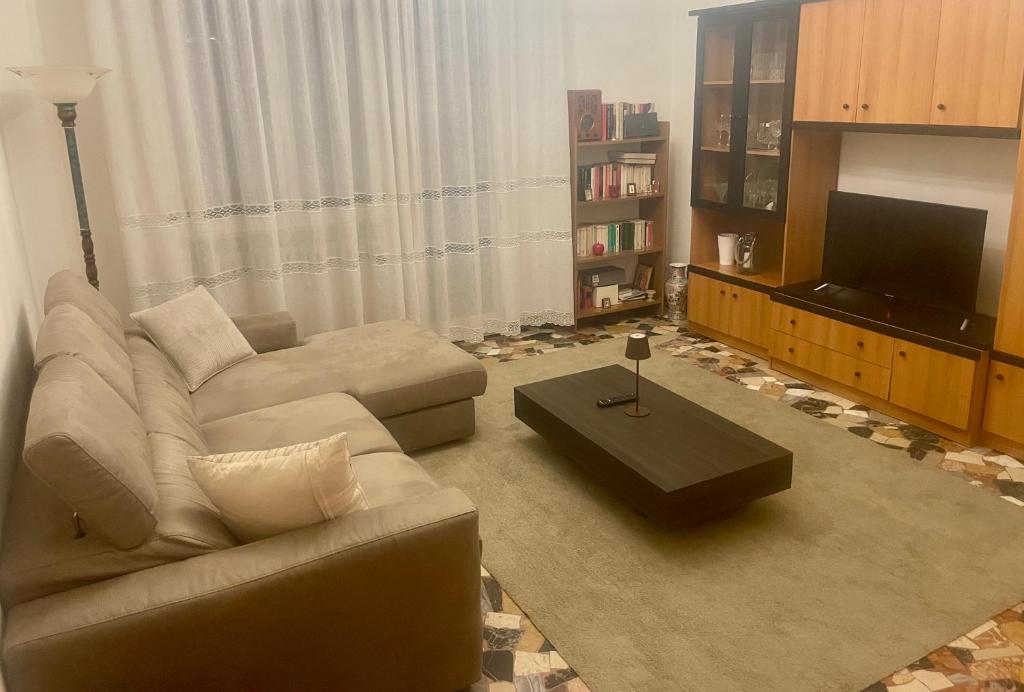 ein Wohnzimmer mit einem Sofa und einem TV in der Unterkunft Rimini Holiday Apartment in Rimini