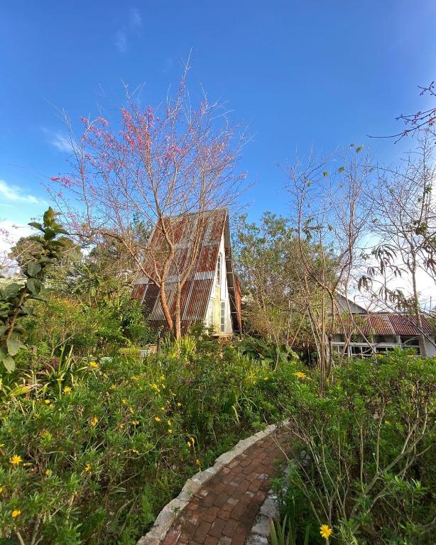 a house with a brick path in front of it at Dreamer Cabin Tre house Dalat in Da Thien