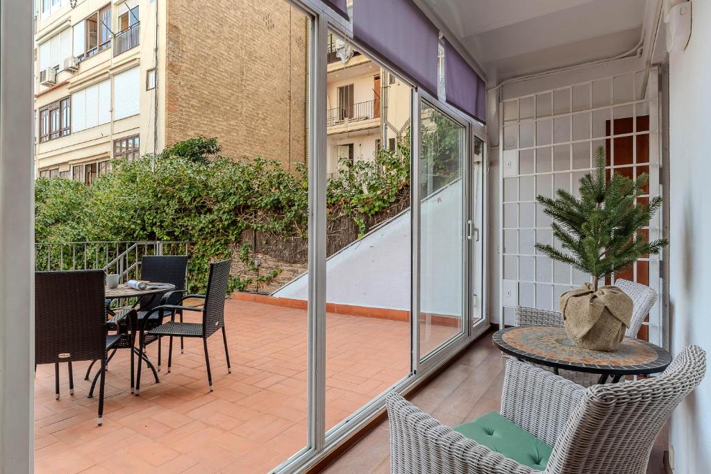 an empty balcony with a table and chairs on a patio at AB Passeig de Gràcia Còrsega in Barcelona