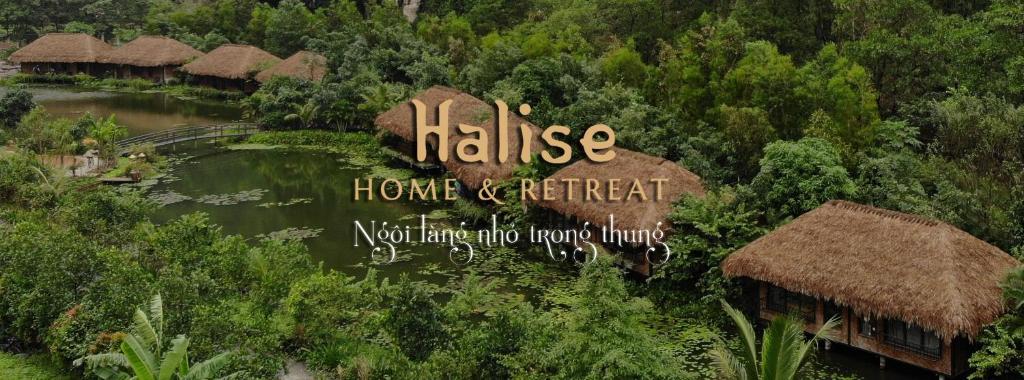 a sign for a resort with a river and trees at Halise Home and Retreat Ninh Binh in Ninh Binh