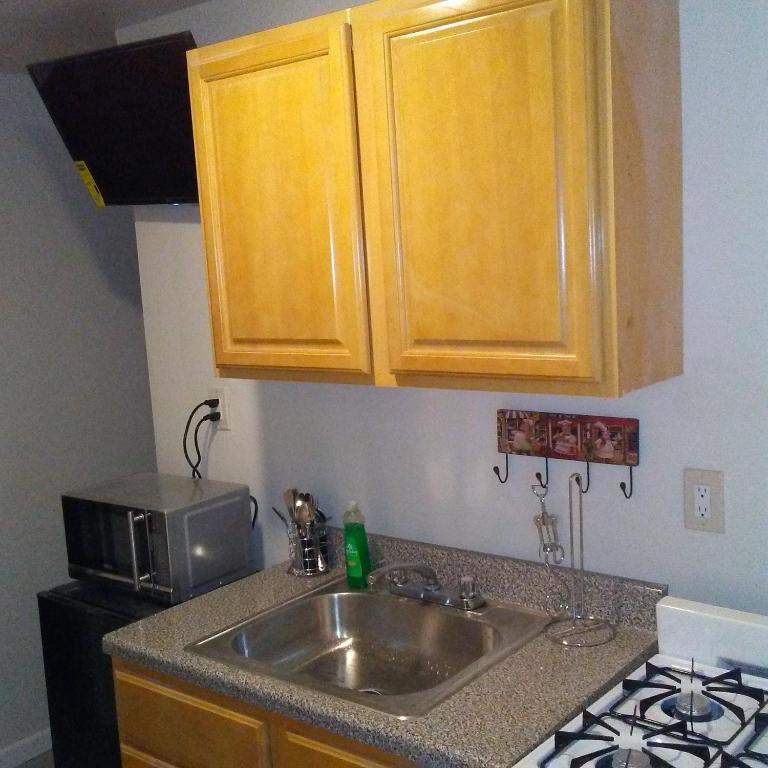 a kitchen with a sink and a microwave at Furman Apartments in Wakefield