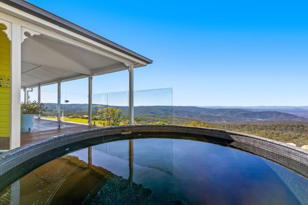 a swimming pool in a house with a view of the mountains at The Quince Cottage - 3 Bedrooms in Ravensbourne