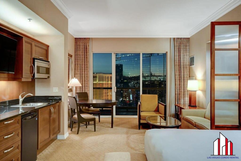 a hotel room with a kitchen and a living room at MGM Signature-33-711 F1 Track & Strip View Balcony in Las Vegas