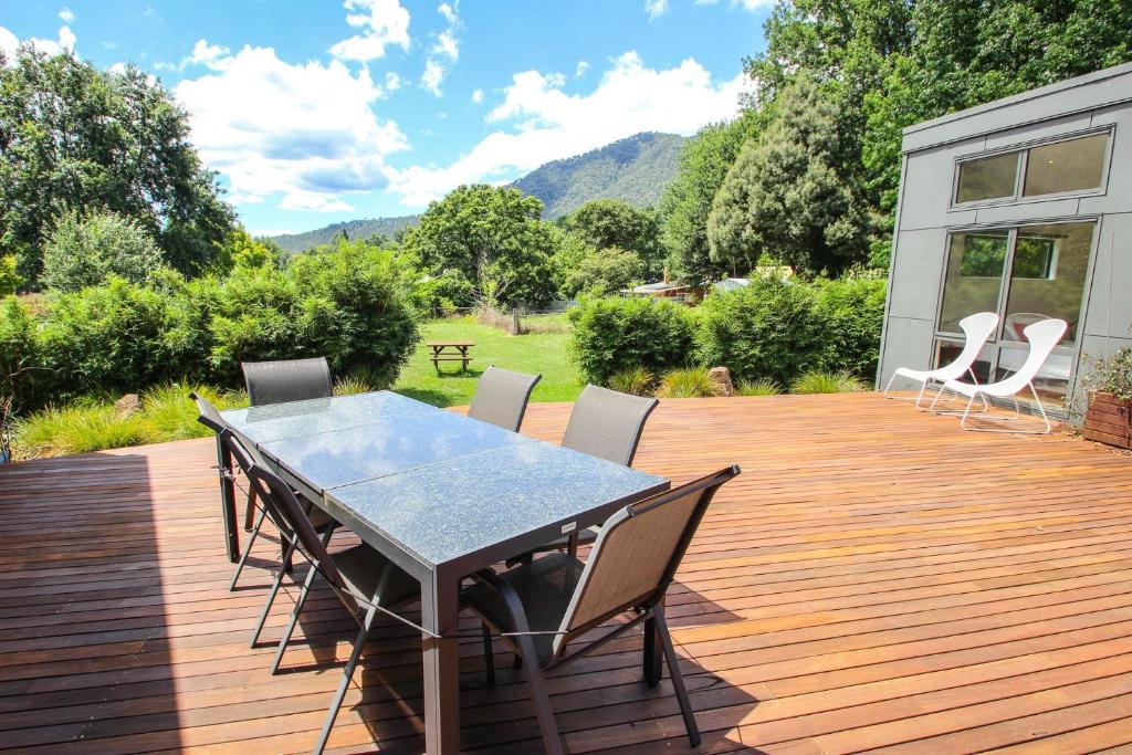 a wooden deck with a table and chairs on it at The Base Two in Harrietville