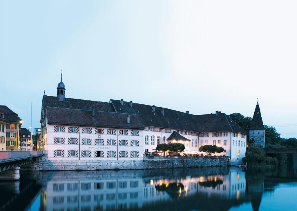 um grande edifício branco ao lado de um rio em Hotel an der Aare Swiss Quality em Solothurn