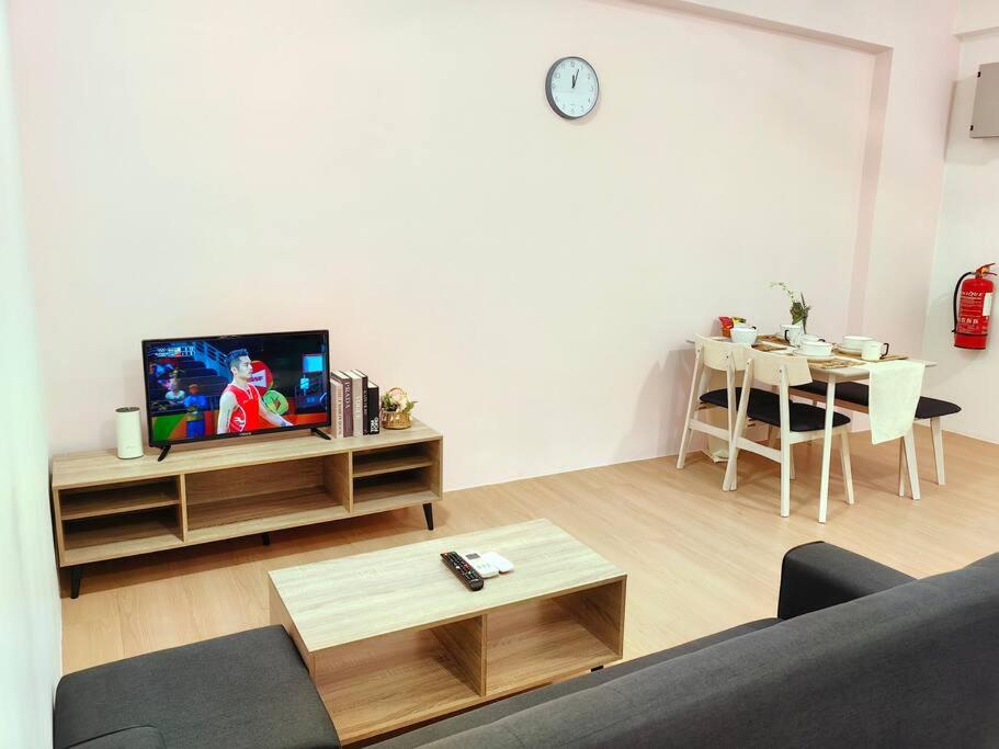 a living room with a couch and a tv at G8 1-8Pax Sunway Medical Center Geo avenue Sunmed in Kampong Penaga