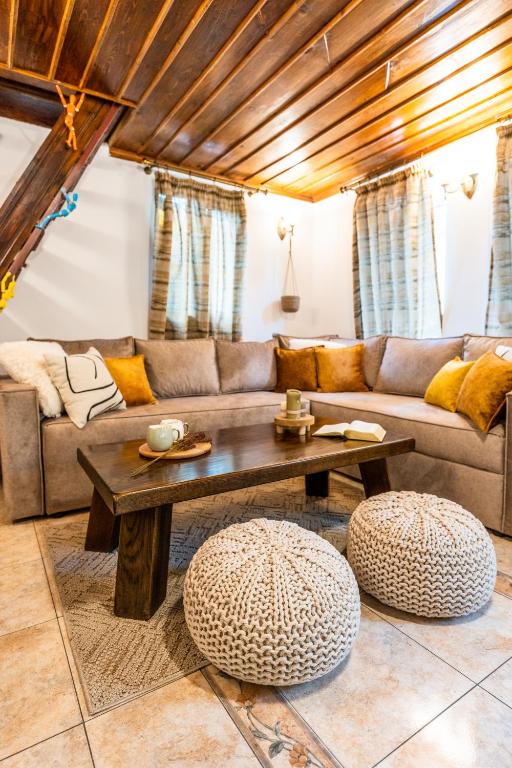 a living room with a couch and a table at Slona, Heritage Home in Old Town Plovdiv in Plovdiv