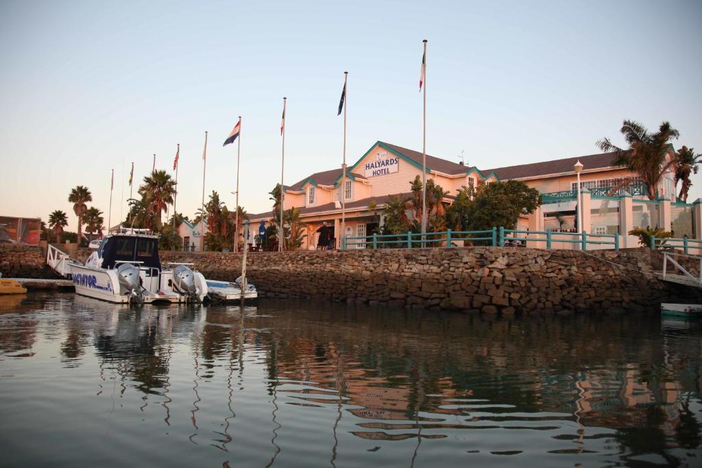 a group of boats docked in a body of water at Halyards Hotel in Port Alfred