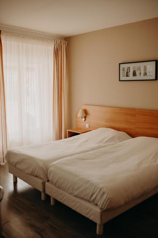 Letto o letti in una camera di Logis - Hotel Restaurant du Parc