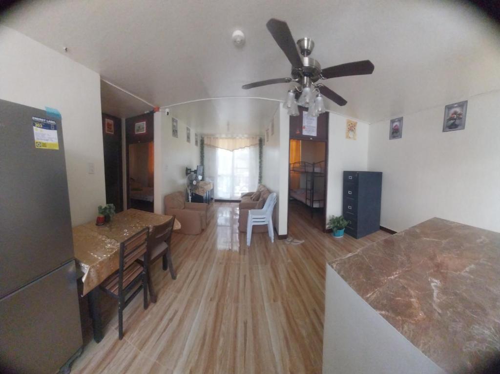 a kitchen and living room with a ceiling fan at ASF Soriano Place in Mactan